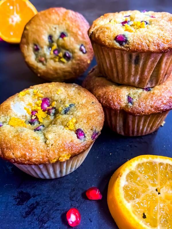 Orange Pomegranate Muffins on a black surface