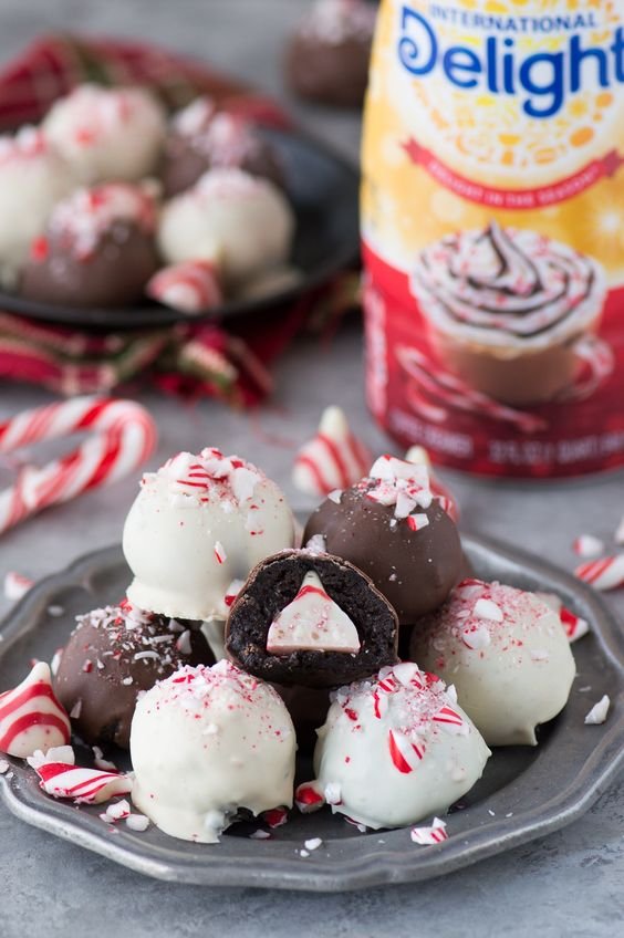 Oreo balls covered in white and dark chocolate with crushed candy canes