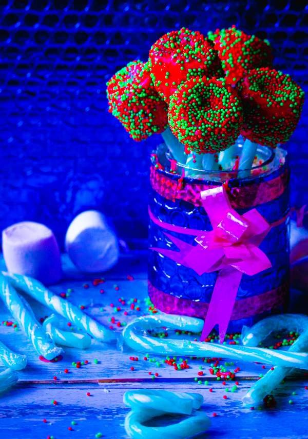 Christmas Candy Cane Marshmallow Pops in a jar with marshmallows and candy canes in front