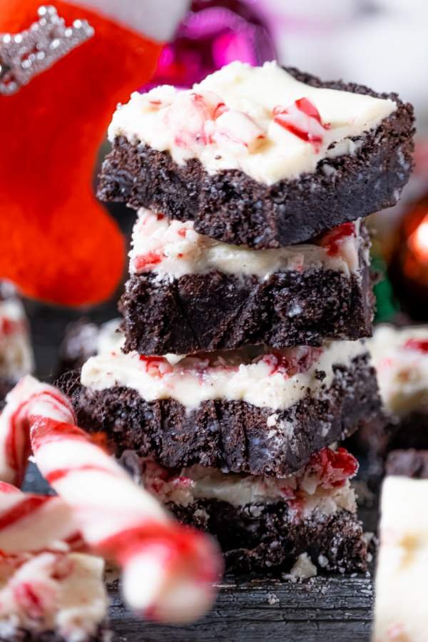 Stack of White Chocolate Peppermint Brownies with candy cane on the side