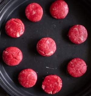 cookies about to go in the oven and arranged on a black plate