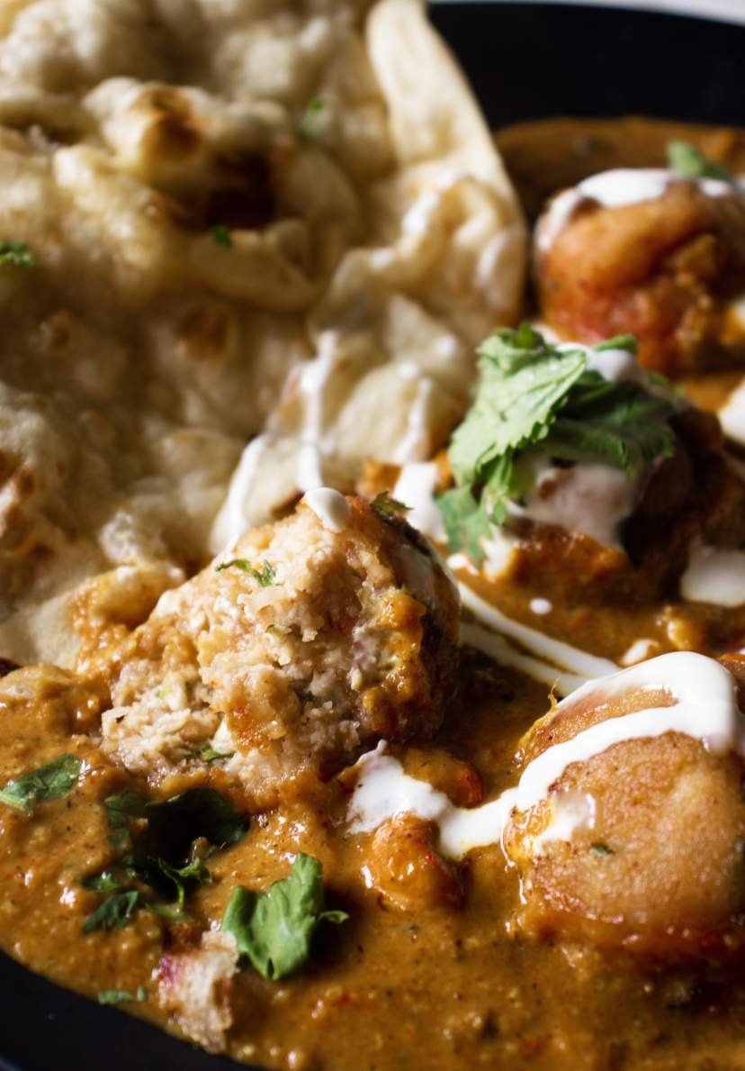 half eaten malai kofta with naan beside