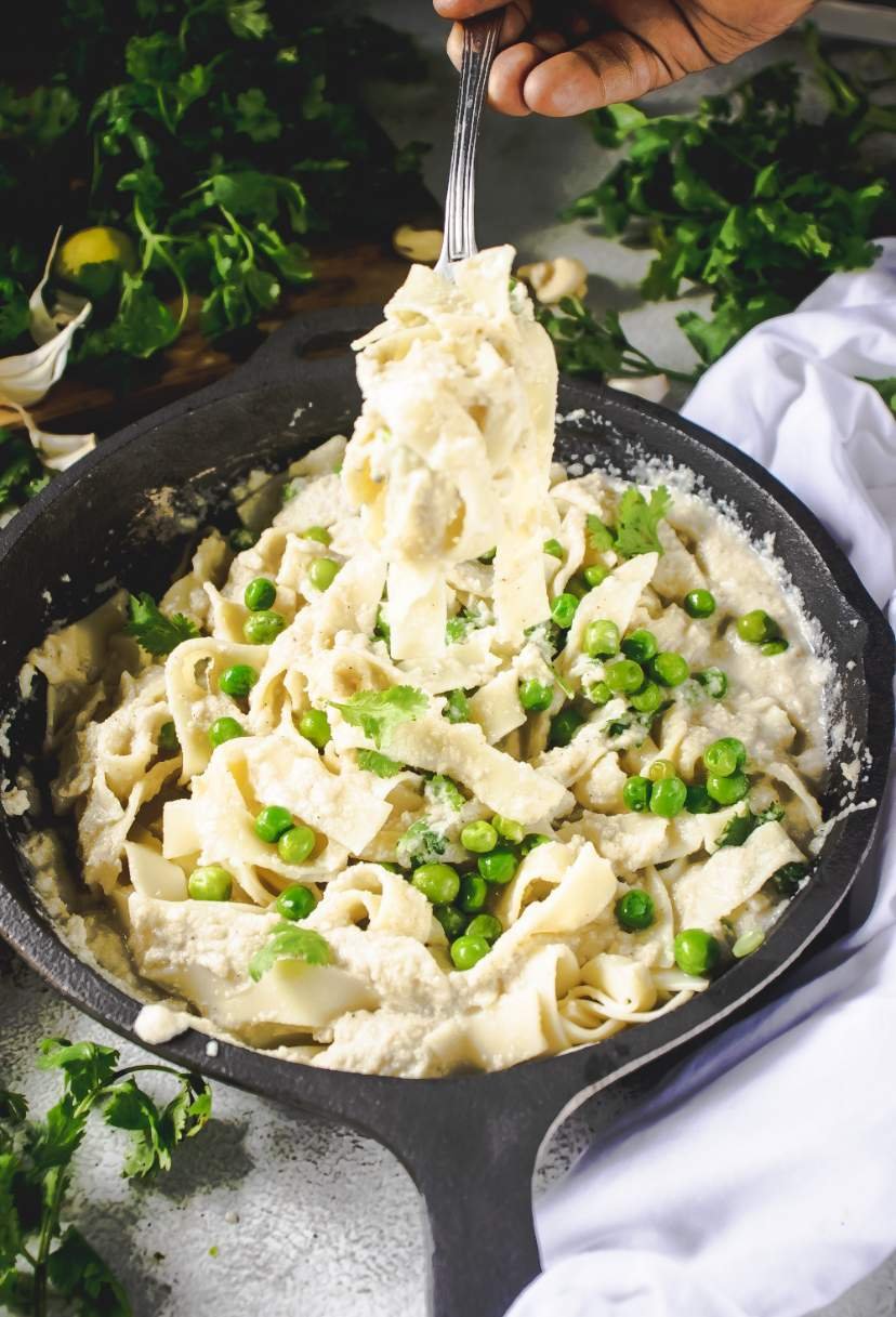 eating vegan fettuccine alfredo with a fork