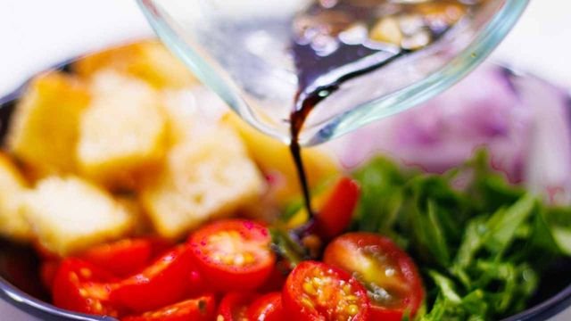 pouring dressing over Panzanella